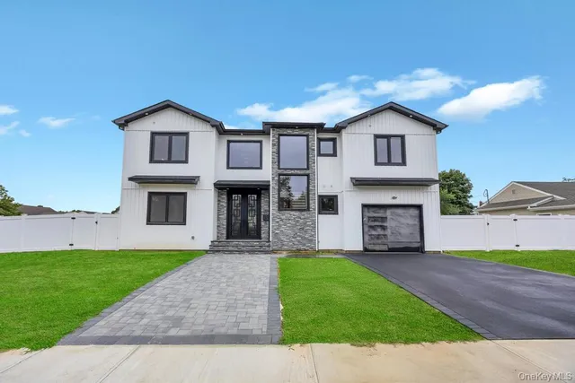 a front view of a house with a garden and yard