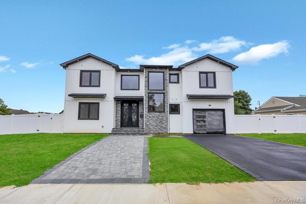 472 Farm Ranch Road East Bethpage, NY 11714 - Photo 2 of 40 a front view of a house with a garden and yard