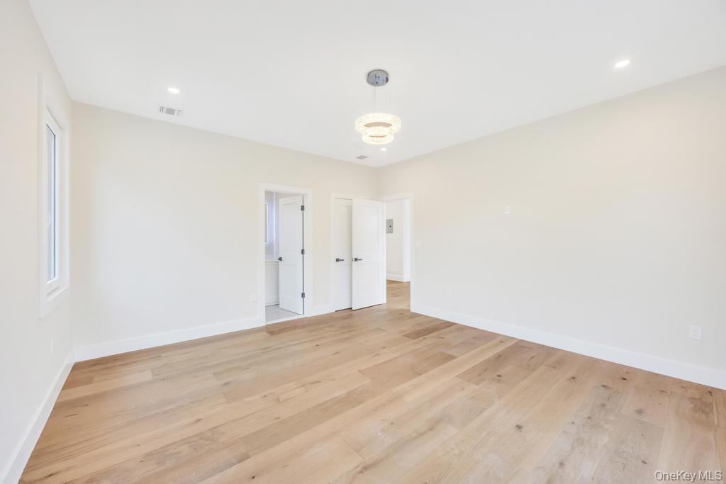 472 Farm Ranch Road East Bethpage, NY 11714 - Photo 21 of 40 Empty room with light wood-style floors and recessed lighting
