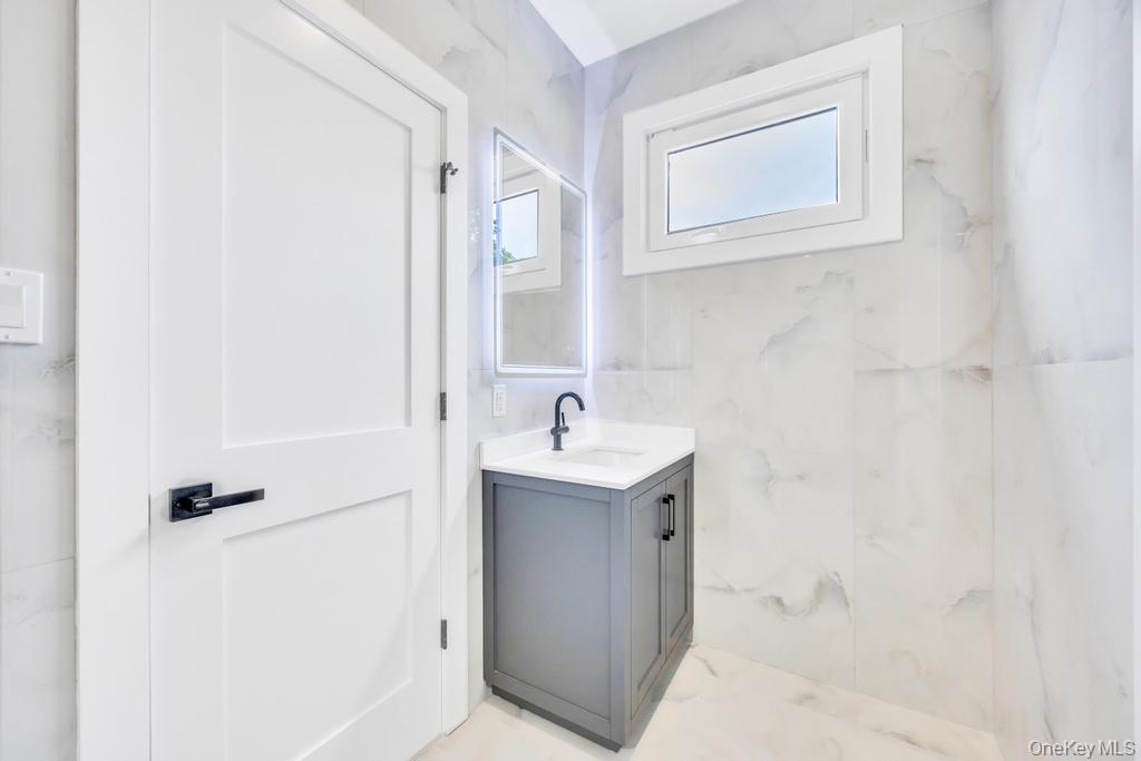 472 Farm Ranch Road East Bethpage, NY 11714 - Photo 26 of 40 a bathroom with a sink a toilet and shower