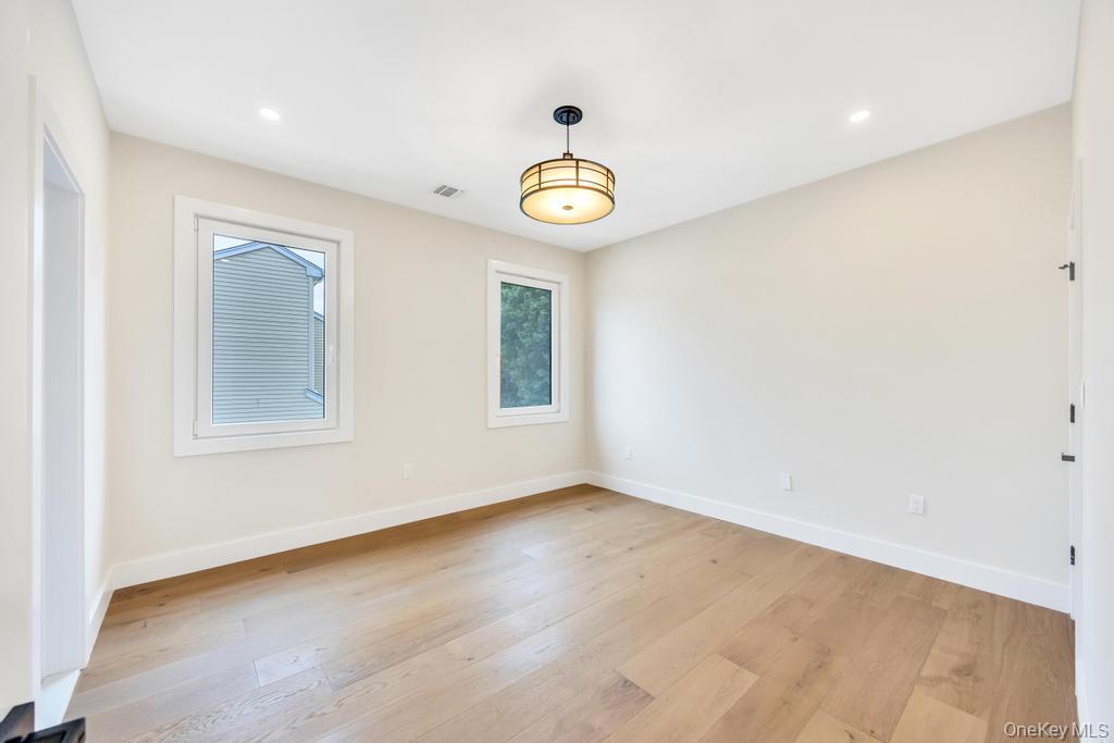 472 Farm Ranch Road East Bethpage, NY 11714 - Photo 28 of 40 an empty room with a window and a ceiling fan