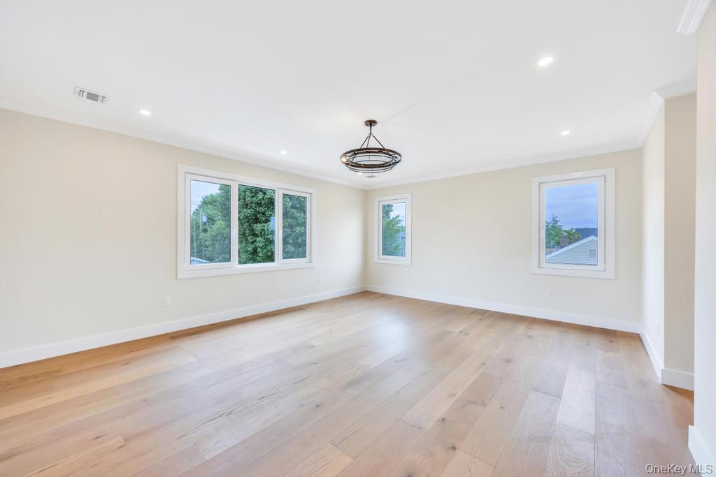 472 Farm Ranch Road East Bethpage, NY 11714 - Photo 29 of 40 an empty room with wooden floor and windows