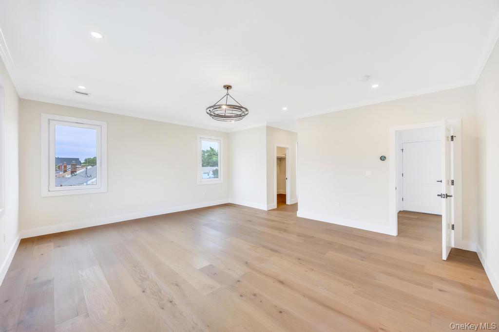 472 Farm Ranch Road East Bethpage, NY 11714 - Photo 30 of 40 a view of an empty room with wooden floor and windows