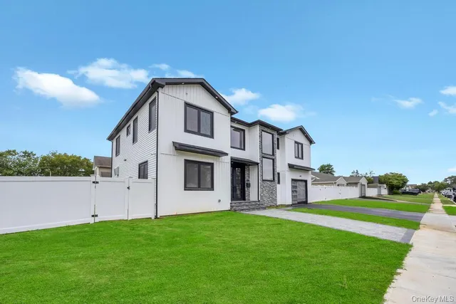 a kitchen with stainless steel appliances kitchen island granite countertop a sink a stove and a wooden floors