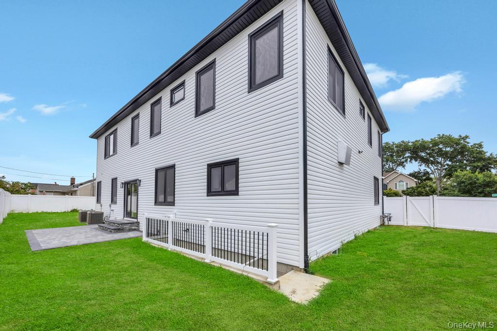 472 Farm Ranch Road East Bethpage, NY 11714 - Photo 37 of 40 a view of backyard with barbeque grill potted plants and wooden fence