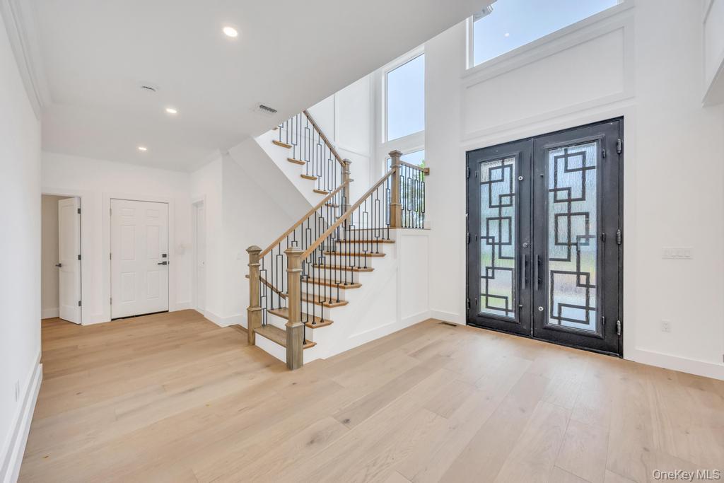 472 Farm Ranch Road East Bethpage, NY 11714 - Photo 9 of 40 a view of an empty room with wooden floor and stairs