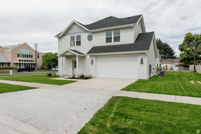 314 North 200 West Logan, UT 84321 - Photo 2 of 37 View of front facade featuring a front yard, concrete driveway, a garage, and a shingled roof
