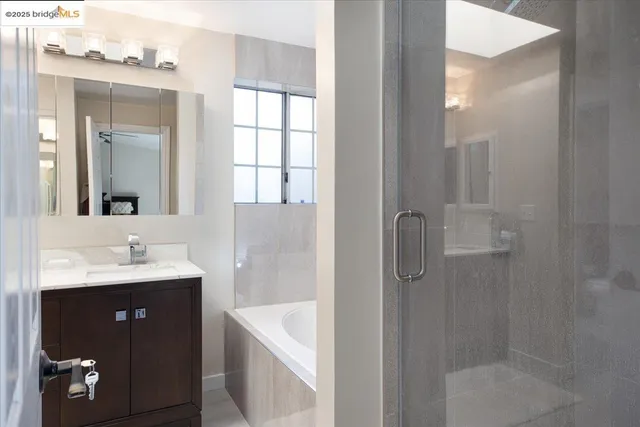 a bathroom with a double vanity sink a mirror and shower