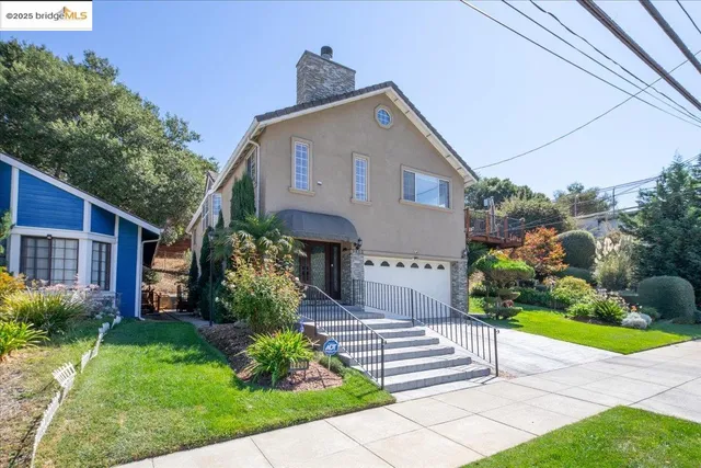 a front view of a house with a garden