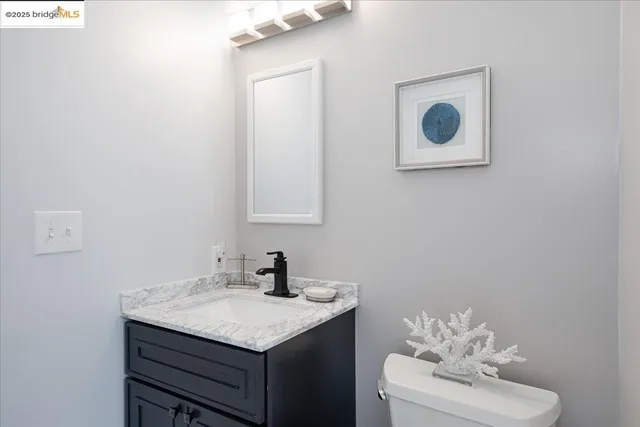 a bathroom with a sink vanity and mirror