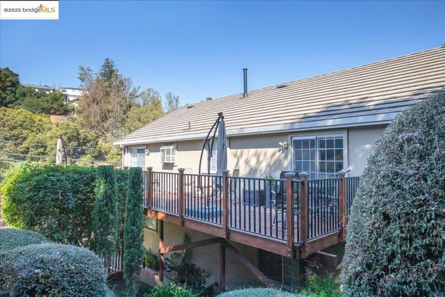 a view of a house with a yard and deck