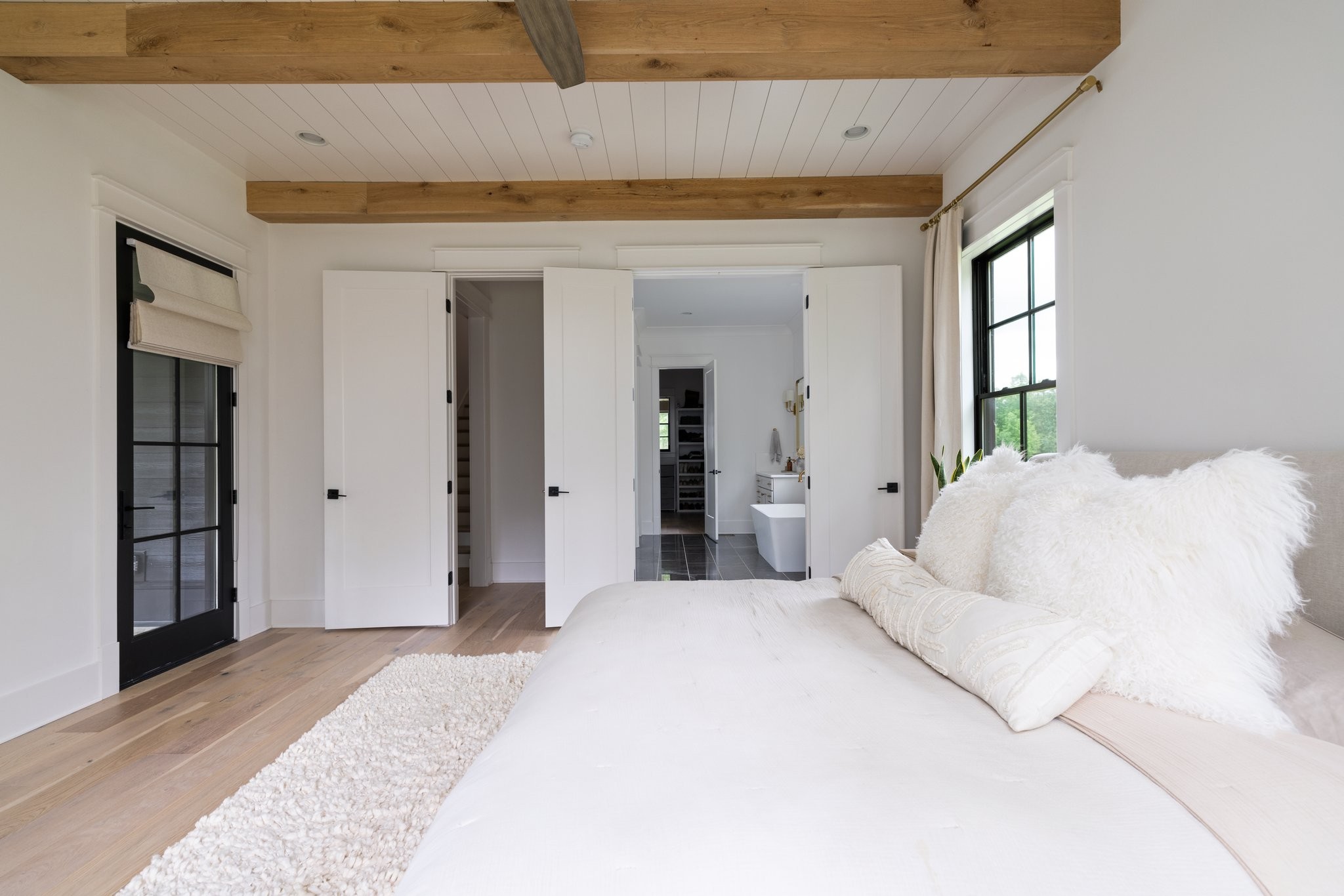 5024 Cobbler Ridge Road Franklin, TN 37064 - Photo 27 of 58 a spacious bedroom with a large bed and a chandelier