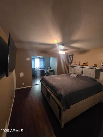 a spacious bedroom with a bed and a television in it