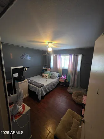 a bedroom with furniture and a mirror