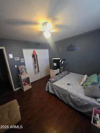 a bedroom with furniture and a wooden floor