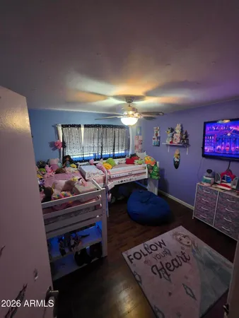 a bedroom with furniture and a book shelf