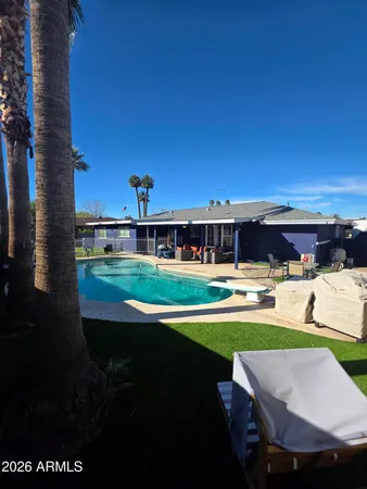 a view of house with swimming pool yard and outdoor seating