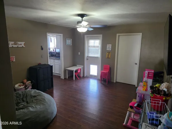 a living room with furniture and wooden floor