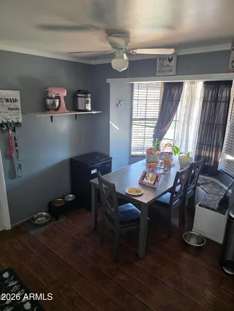 a view of a workspace with furniture window and wooden floor