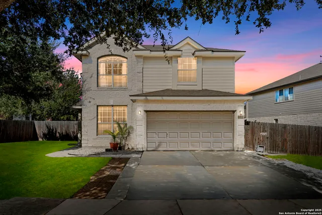 a front view of a house with a yard and garage