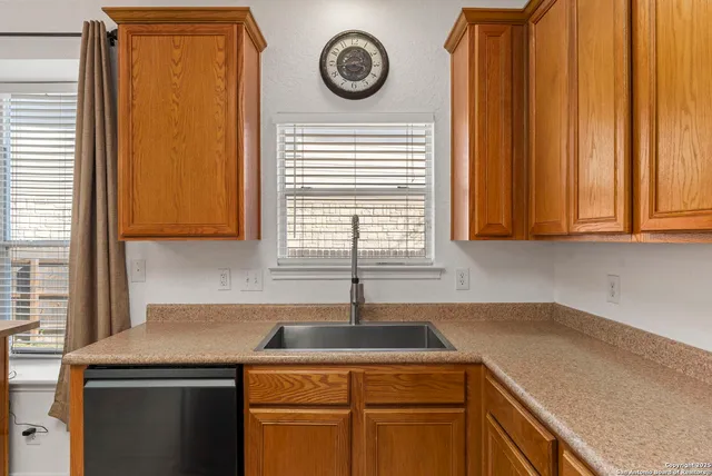 a kitchen with a sink a cabinets and window