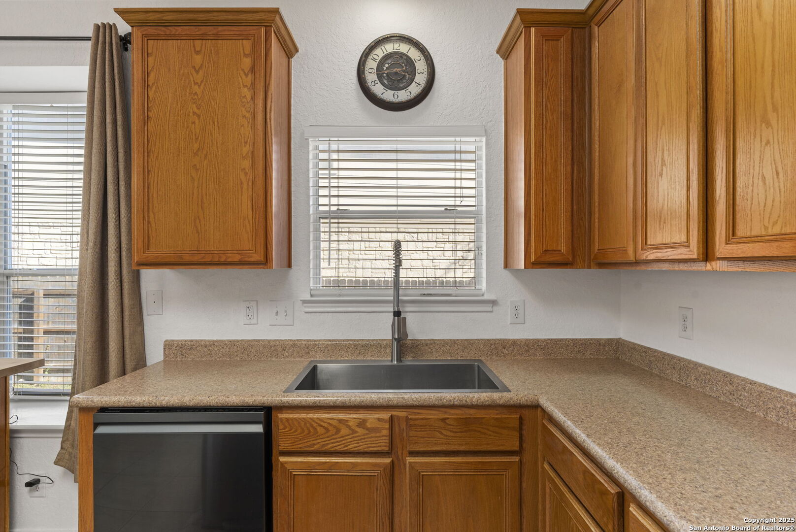 8947 Burnt Path Helotes, TX 78023 - Photo 12 of 34 a kitchen with a sink a cabinets and window