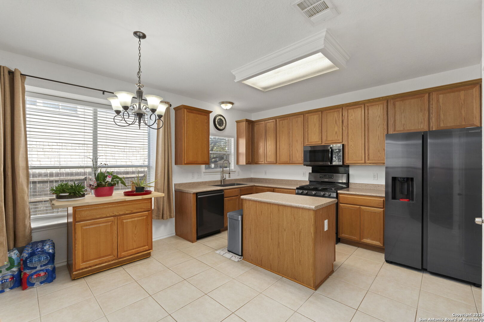8947 Burnt Path Helotes, TX 78023 - Photo 13 of 34 a kitchen with stainless steel appliances a stove refrigerator sink and microwave