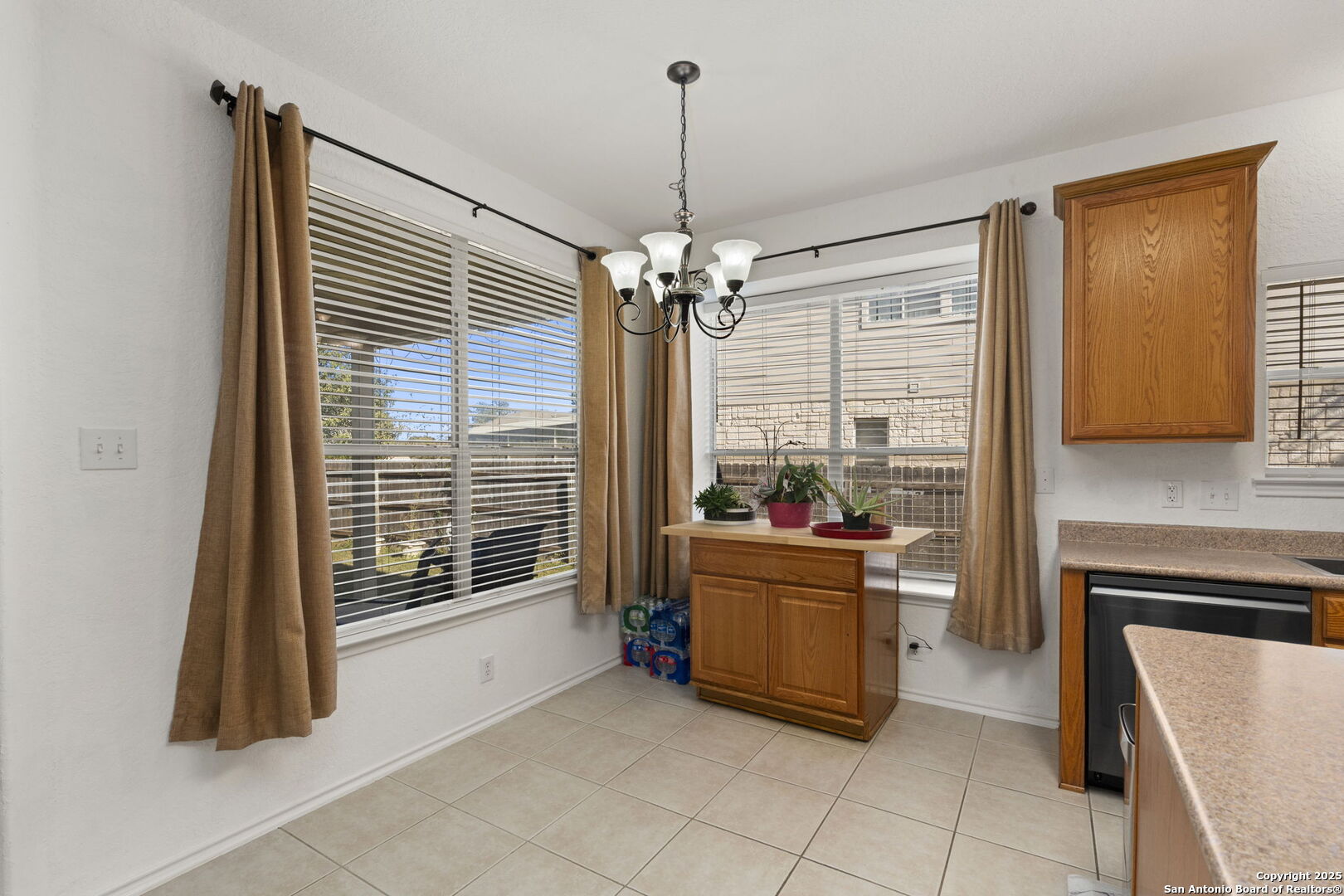 8947 Burnt Path Helotes, TX 78023 - Photo 14 of 34 a living room with furniture and a chandelier