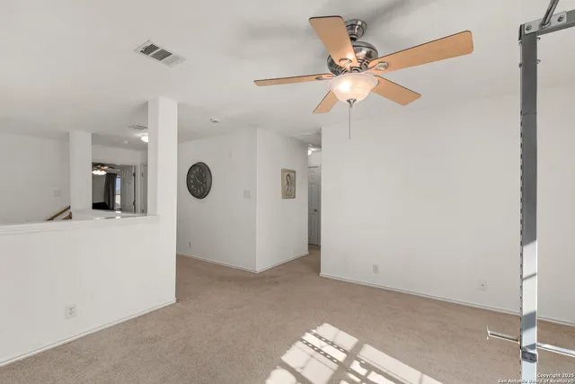 a view of a livingroom with a ceiling fan and a fan
