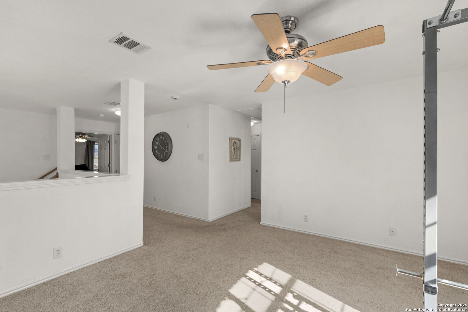 8947 Burnt Path Helotes, TX 78023 - Photo 23 of 34 a view of a livingroom with a ceiling fan and a fan