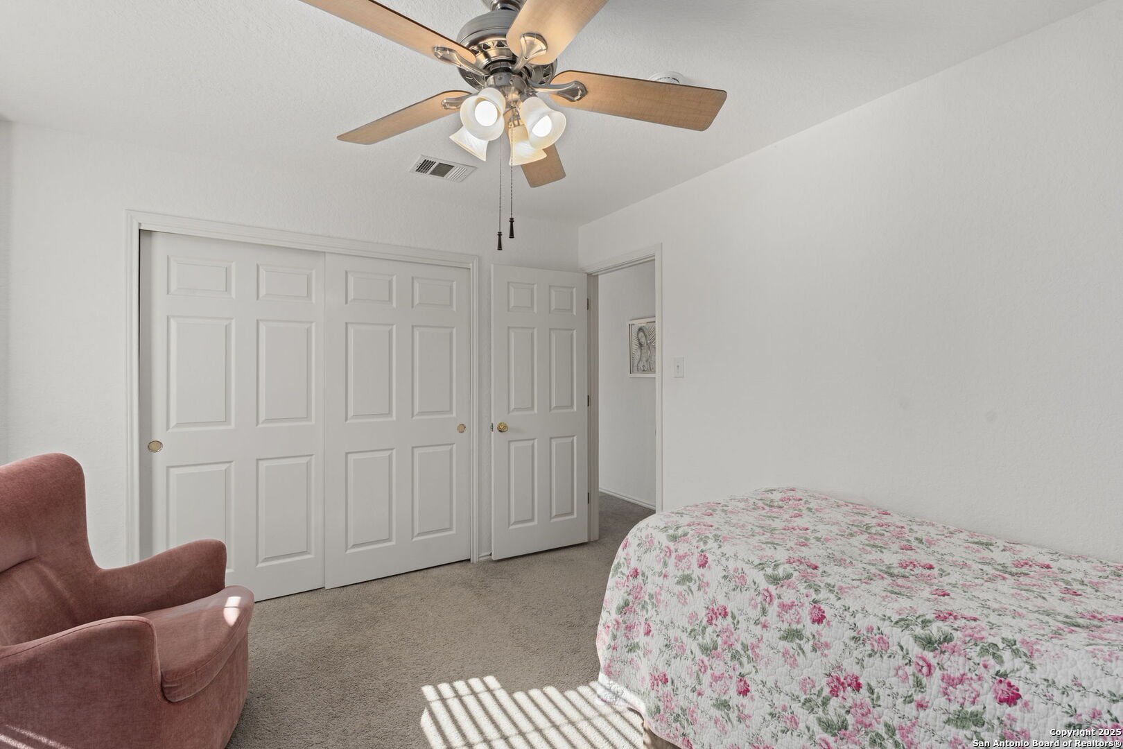 8947 Burnt Path Helotes, TX 78023 - Photo 28 of 34 a bedroom with a bed and a chandelier