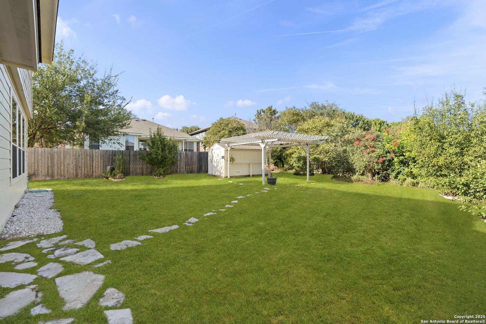 8947 Burnt Path Helotes, TX 78023 - Photo 34 of 34 a view of a white house with a big yard plants and large trees