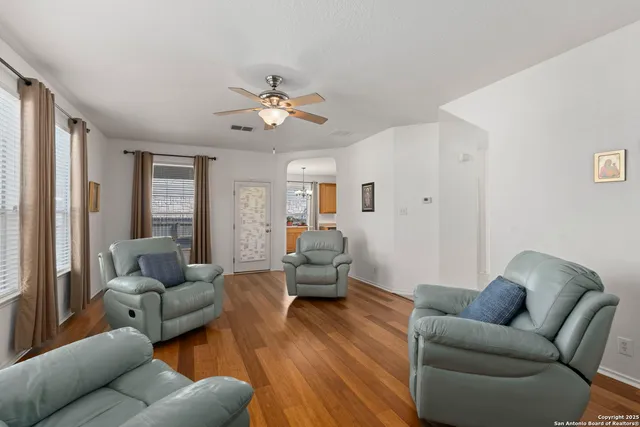 a living room with furniture and wooden floor