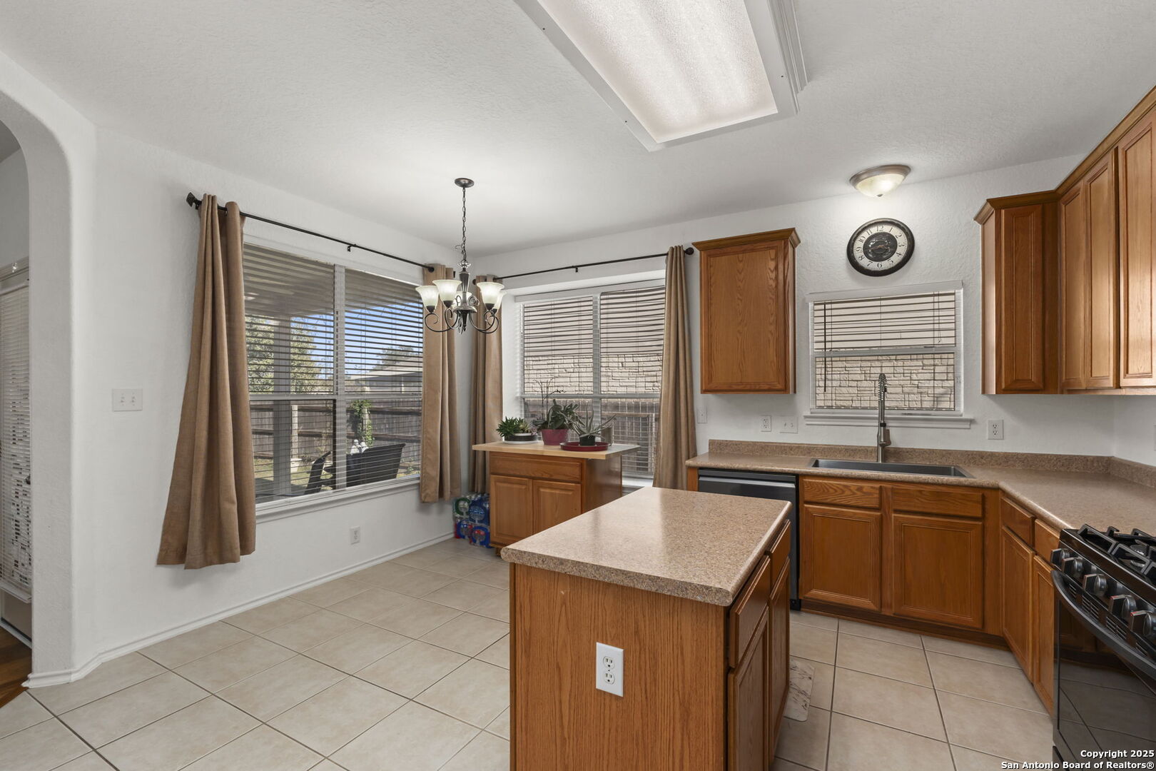 8947 Burnt Path Helotes, TX 78023 - Photo 10 of 34 a kitchen with a stove a sink and a refrigerator