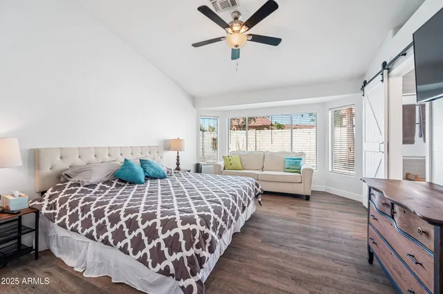 a bedroom with a bed and a window