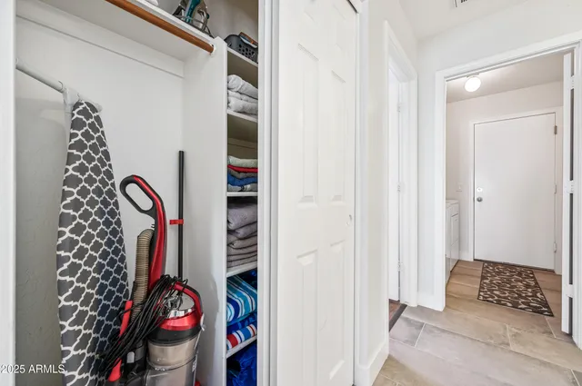 a bedroom with a bed a mirror and a large window
