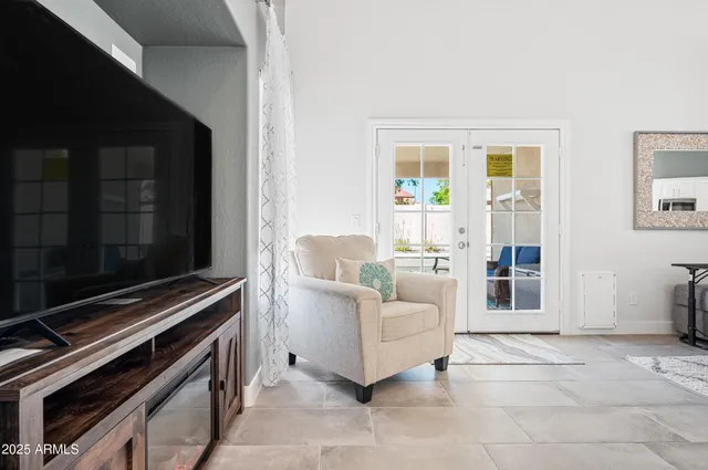 a backyard of a house with barbeque oven table and chairs