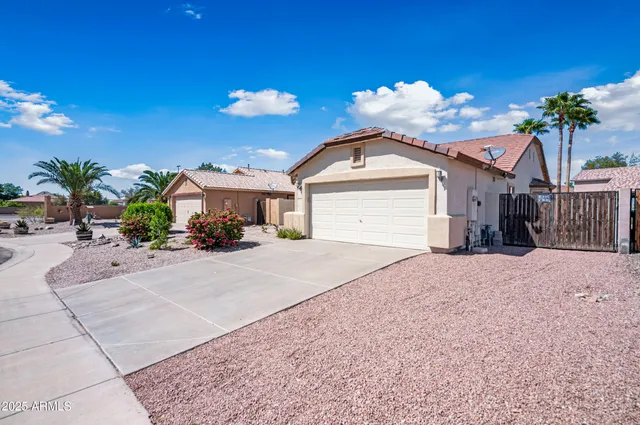 a view of a house with a yard and a garage
