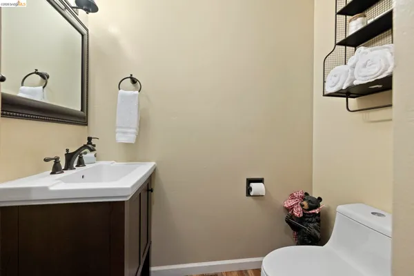 a bathroom with a sink mirror and toilet