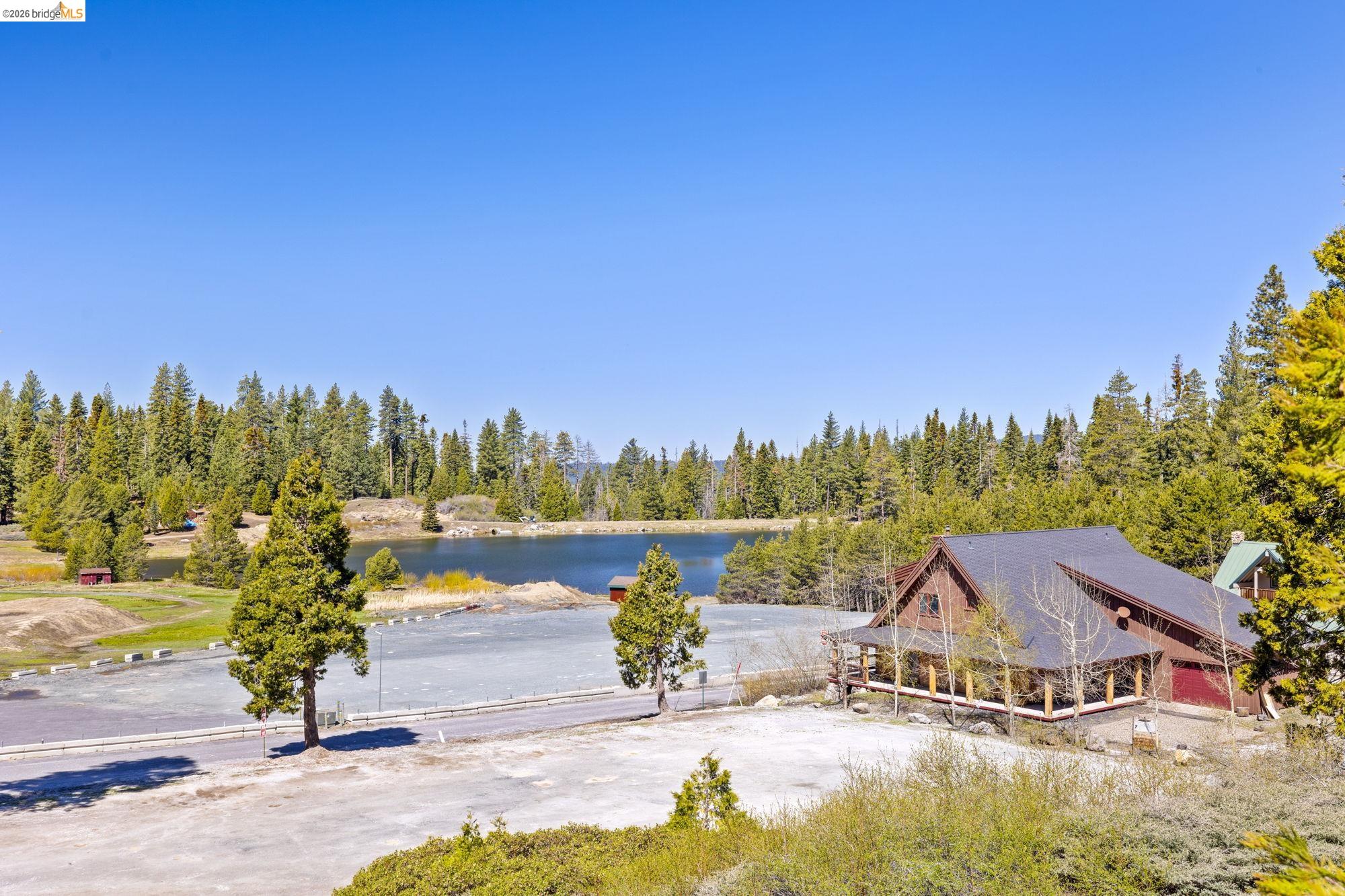 33757 Upper Leland Road, Unit B Pinecrest, CA 95364 - Photo 15 of 39 a view of a lake with a yard and large trees