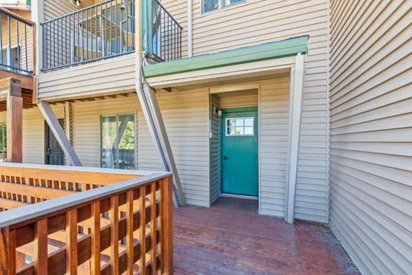a view of a balcony with furniture and wooden deck