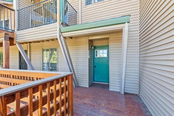 a view of a balcony with furniture and wooden deck