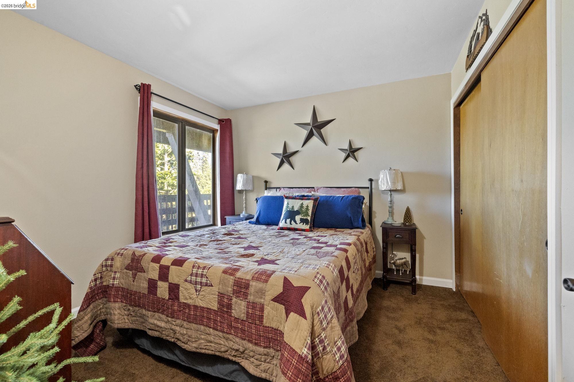 33757 Upper Leland Road, Unit B Pinecrest, CA 95364 - Photo 20 of 39 a bedroom with a bed and a window