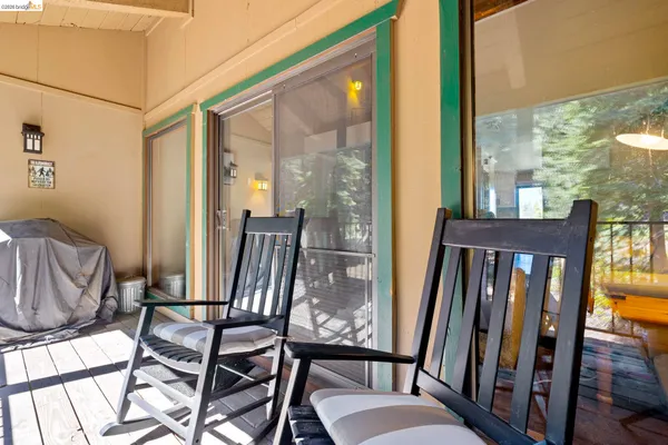 a view of a balcony with furniture