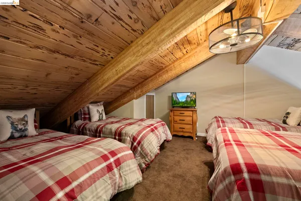 a bedroom with two beds and painted walls