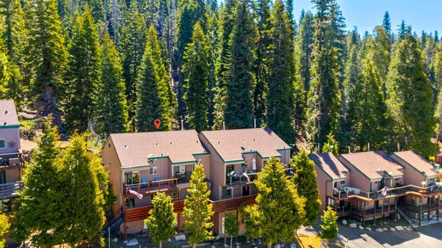 an aerial view of a house with swimming pool and garden