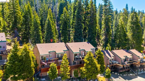 an aerial view of a house with swimming pool and garden