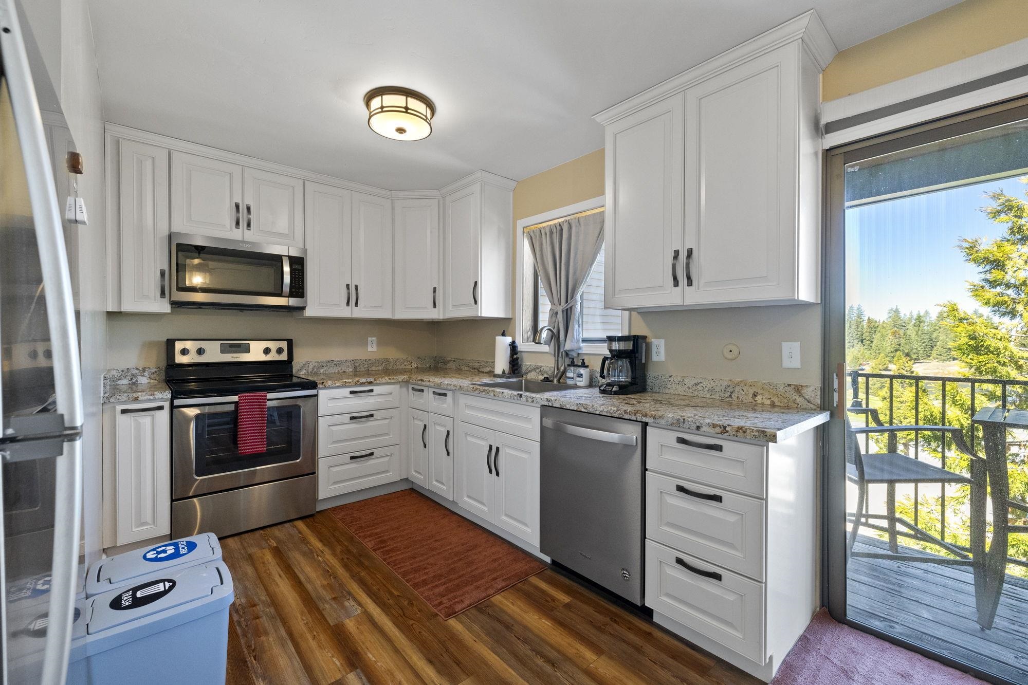 33757 Upper Leland Road, Unit B Pinecrest, CA 95364 - Photo 4 of 39 a kitchen with granite countertop a stove top oven microwave and cabinets
