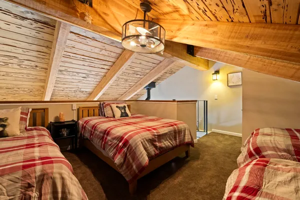 a bedroom with two beds and a night stand