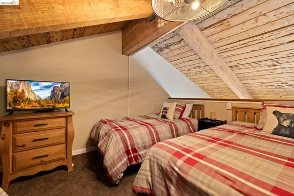 a bedroom with two beds and painting on the wall